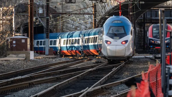A blue and white train emerges from the Baltimore and Potomac Tunnel.