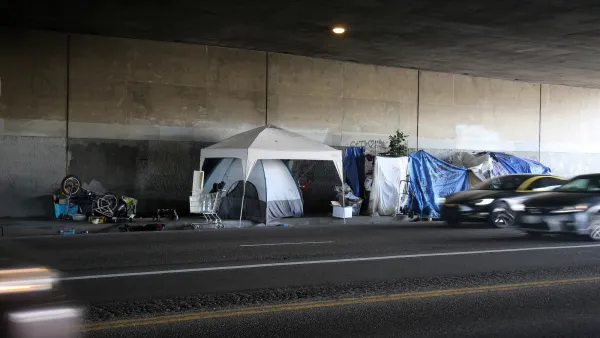 Encampment of tents and camopies built by unhoused people in freeway underpass in Venice, California.