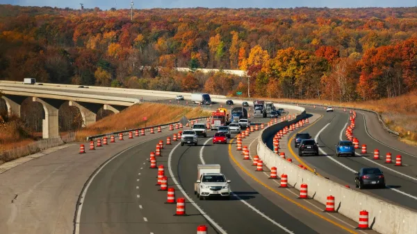 Cars driving on Ohio freeway with orange cones blocking off one lane.