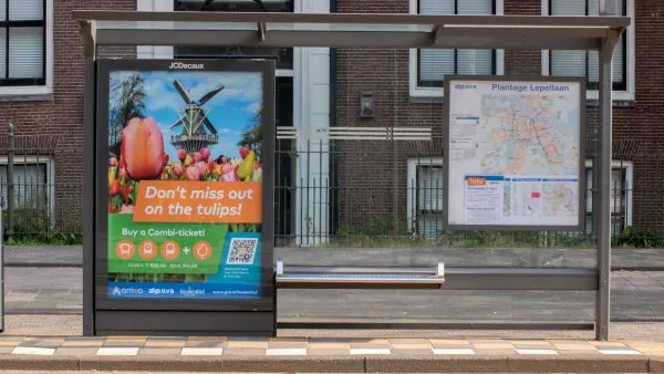 Bus stop with shelter and advertising panel in Amsterdam, Netherlands.
