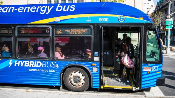 Blue clean-energy hybrid gas-electric bus in New York City.