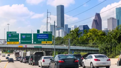 Traffic on freeway in Houston, Texas with downtown buildings in background