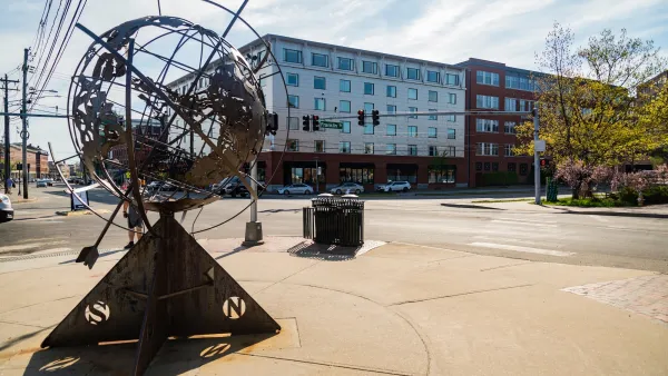 Plaza in Portland, Maine with statue of globe with compass rose.