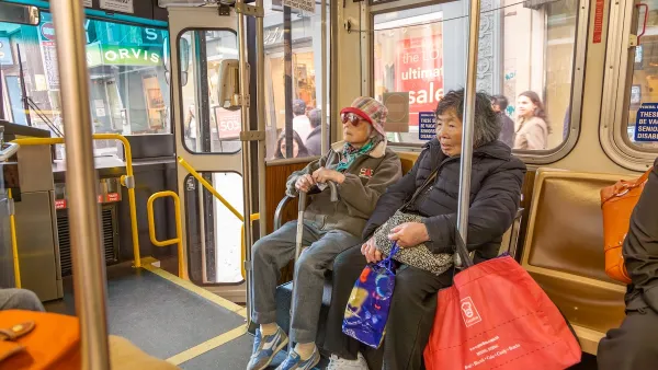 Two women sit inside a Metropolitan Transit System streetcar.