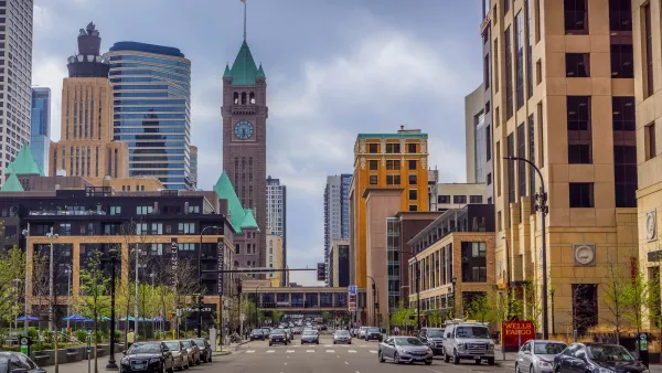 Downtown Minneapolis, Minnesota skyline from street with tall red brick building with green top.