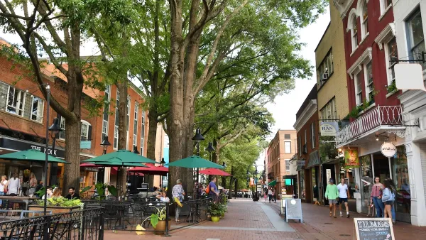 Walkable red brick street with restaurant patios and small shops in Charlottesville, Virginia.
