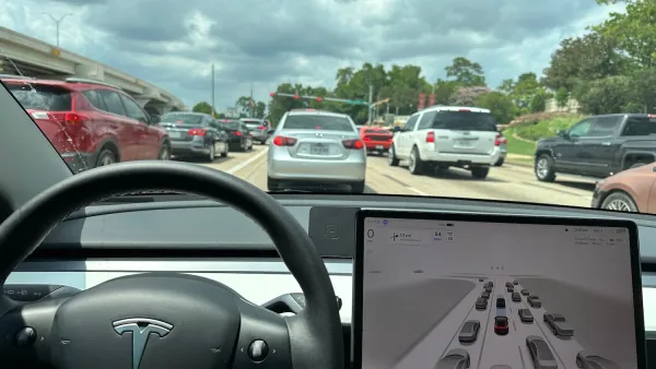Interior of TEsla vehicle facing out from driver's seat.