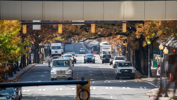 A busy road in Charlotte, NC, with cars driving towards an elevated camera.