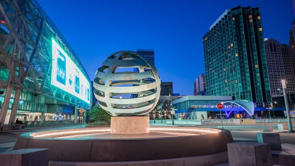 Spherical sculpture lit from underneath in front of convention center in downtown Detroit, Michigan.