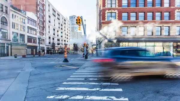 Blurred car passing through crosswalk in downtown Detroit, Michigan.