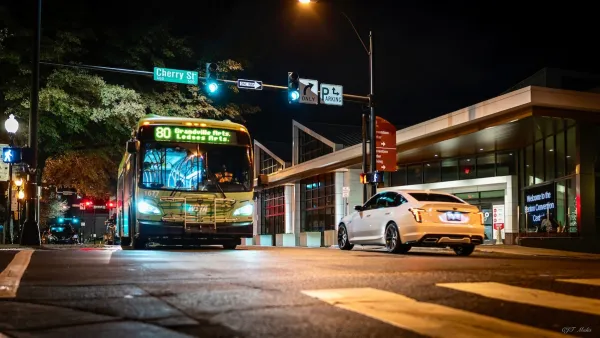 Winston-Salem transit bus on street at night.