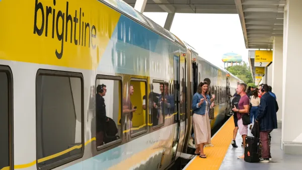 Yellow and white Brightline high-speed rail train at platform in Ft. Lauderdale, Florida.