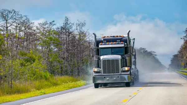 Big rig truck driving alone down two-lane Florida highway.
