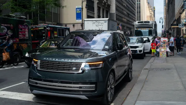 Dark-colored Range Rover SUV on street in Manhattan, New York City.