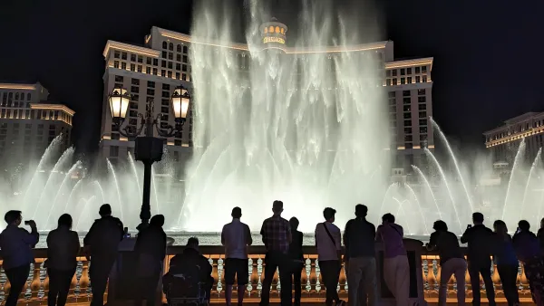 A crowd of people gather to watch the famous water fountain show in front of the Bellagio hotel in Las Vegas.