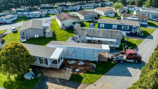 Aerial of manufactured homes being installed.