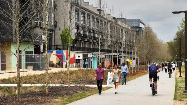 People walking and biking on Atlanta Beltline paved trail.