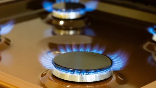 Close-up on blue flame on natural gas kitchen stove.