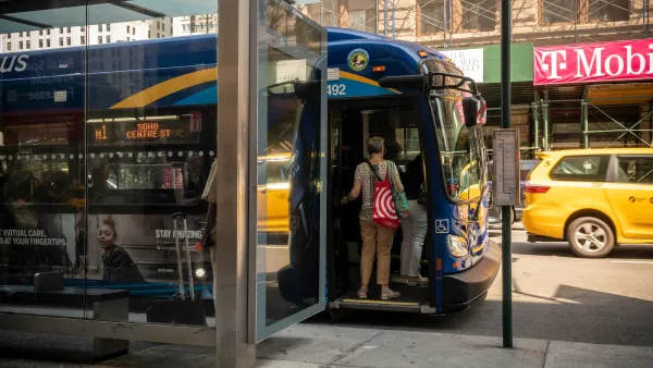 Person boarding blue city bus at New York City bus stop.