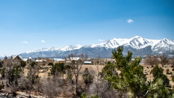 View of small mountain town of Buena Vista, Colorado with snow-capped mountains in background.