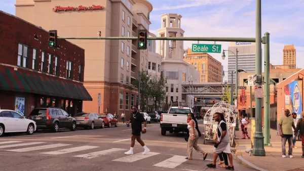 People crossing a crosswalk on Beale Street in Memphis, Tennessee.