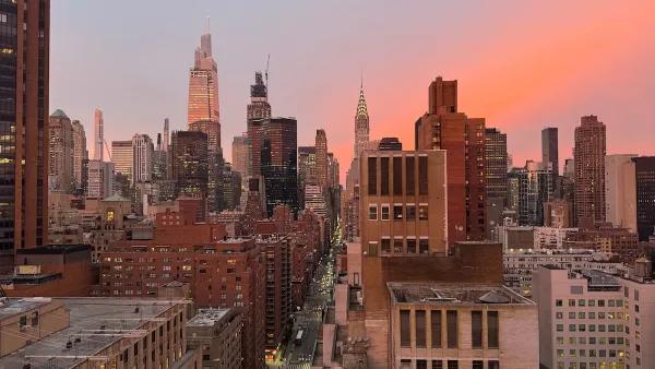 Midtown Manhattan skyline with Chrysler Tower in background against colorful sunset.