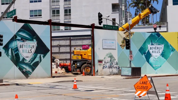 Construction site for Los Angeles Metro underground station with Beverly Hills city logo on construction fences.