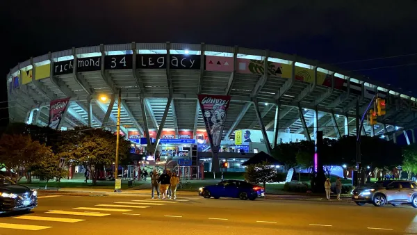 Fans walking away from Flying Squirrels minor league baseball stadium in Richmond, Virginia at night.