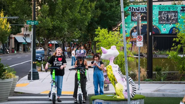 Teens on scooters crossing a crosswalk.