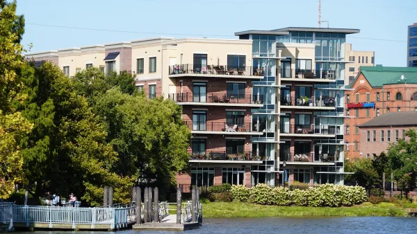 Four story apartment building with balconies on lake or river in Wilmington, Delaware.