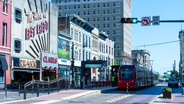 Red light rail train on street in downtown Houston, Texas.