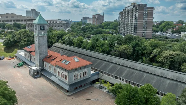 Aerial of historic Mount Royal gray train station with red tile roof in Baltimore, Maryland.