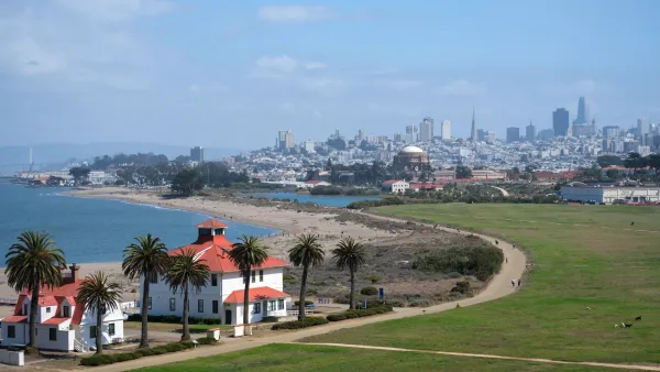 View of Spanish-style buildings in Presidio, San Francisco with city skyline in background.