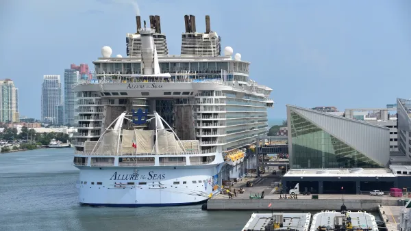 Large white cruise ship docked in port in Miami, Florida.
