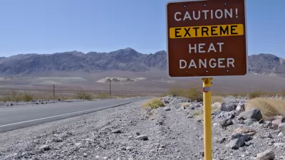"Caution! Extreme heat danger" sign in Death Valley National Park with desert mountains in background