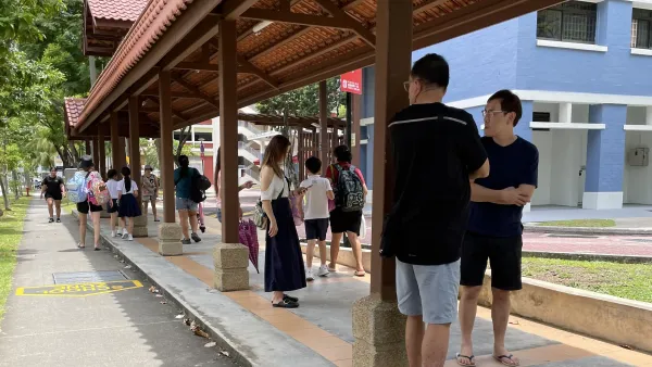 People standing under a covered walkway in Singapore
