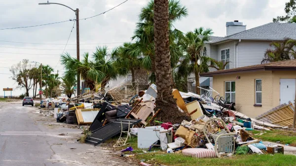Houses with debris from hurricane piled on front lawns in Florida.