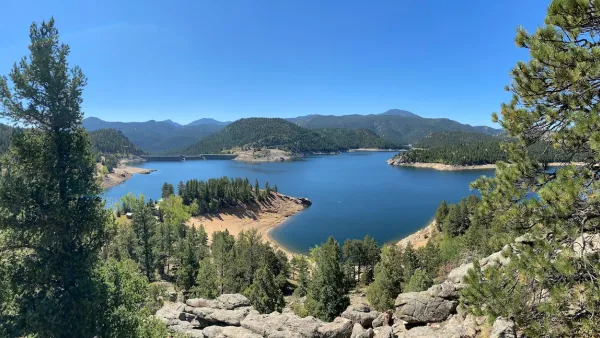 The Gross Reservoir, a large body of water surrounded by trees and mountains.