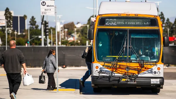 Passengers boarding orange Los Angeles Metro bus on a sunny day.