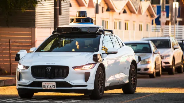 White Waymo self-driving taxi in Los Angeles, California.
