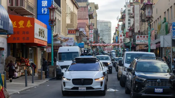 White Maymo robotaxi seen from front stopped at intersection in Chinatown in San Francisco, California.