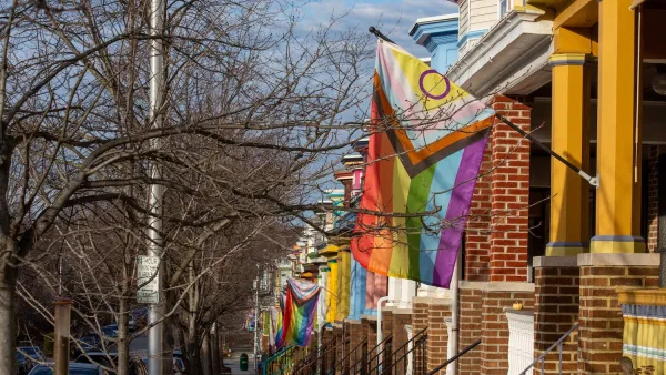 Rainbow flags on brick row houses in Baltimore, MD.
