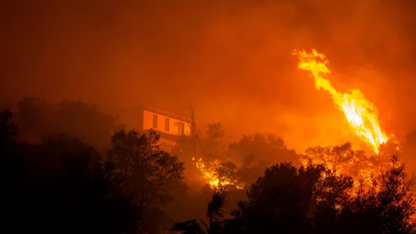 The Eaton fire burns in Sierra Madre. A home can be seen through the flames.