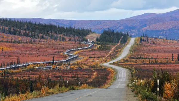 A pipeline runs parallel to the Dalton Highway, which is otherwise surrounded by untouched nature.