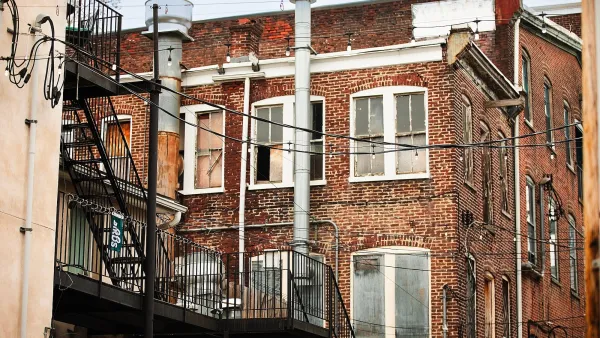 REd brick apartment buildings from back with fire escapes in Philadelphia, PA.