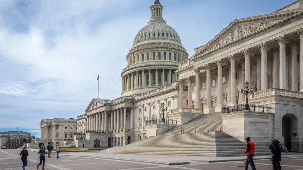U.S. Capitol Dome in Washington, DC with a few people walking in front.
