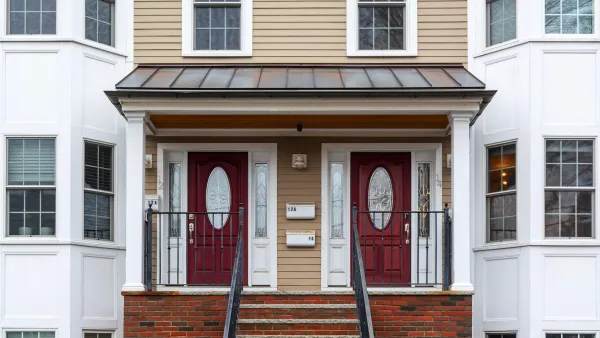 Two-story duplex with matching dark red doors in Boston, Massachusetts.