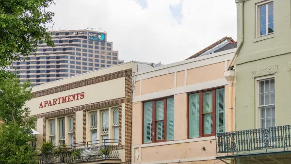 New Orleans apartment buildings with high-rise office building behind them.