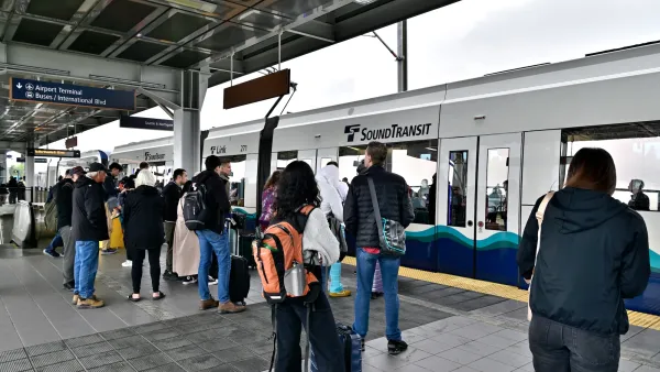 Crowd waiting on platform as Sound Transit train pulls in in Seattle, Washington.