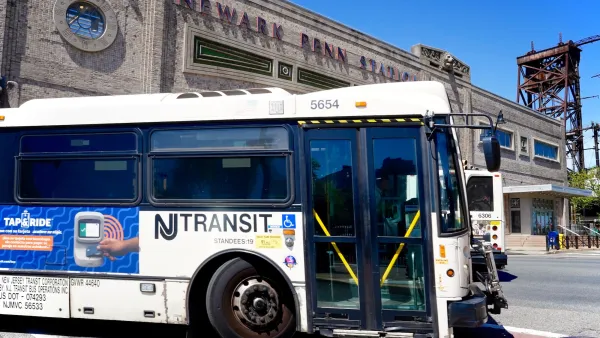 White and blue NJ Transit bus in front of Newark Penn Station in Newark, New Jersey.